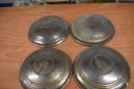 Four Austin hub caps, possibly A90.