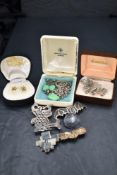 A selection of silver and white metal jewellery including brooches, clip earrings, chains etc
