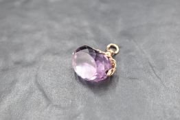 An amethyst seal fob having gold chain fitting and carved initials, marks worn