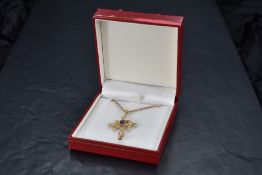 A 9ct gold pendant having seed pearl and amethyst decoration on a 9ct gold open rope chain, approx