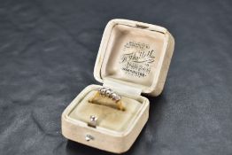 A five stone graduated diamond ring, total approx 0.35ct in a claw set mount on a yellow metal