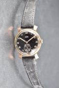 A gent's 9ct gold wrist watch by Trebex having Arabic numeral with subsidiary seconds to black