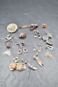 A selection of silver and white metal earrings and brooches including filigree, amber, Celtic