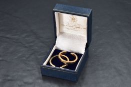 A pair of 9ct gold hoop earrings in the 'love' style, approx 3.1g, one post broken