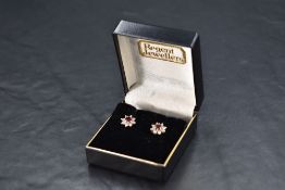 A pair of ruby and diamond cluster stud earrings having 18ct white gold fittings, approx 2.6g gross