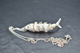 A silver articulated fish pendant with chain, approx 19.7g