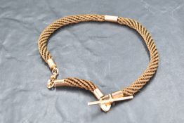 An early 20th century plaited hair watch chain having rose gold fittings stamped 9ct