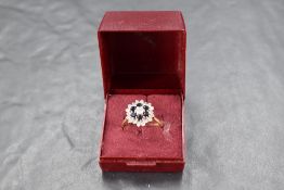 A sapphire and diamond triple daisy cluster ring having central brilliant cut diamond approx 0.