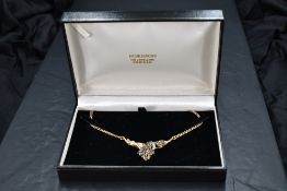 A 9ct gold pendant having 20 marquise and brilliant cut powder blue sapphires loosely modelled as
