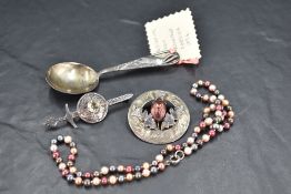 An HM silver christening spoon bearing a stork to terminal, Chester 1956, two Celtic silver brooches