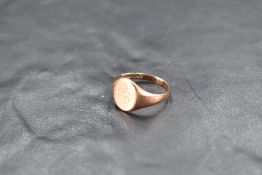 A small 9ct rose gold signet ring bearing a worn monogram, size J/K & approx 2.6g