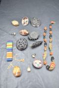 A case containing a small selection of vintage costume brooches including mourning brooches,