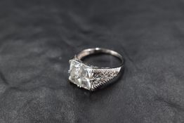 A four stone princess cut cubic zirconia set ring of square form with open cut shoulders on 9ct