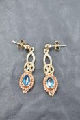 A pair of 9ct Clogau gold stud earrings having knot drops to blue topaz stobes, approx 6.2g