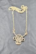 A 9ct gold necklace modelled as a Celtic knot on a fixed 9ct gold rope chain, approx 16' & approx