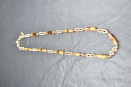 A 9ct gold necklace having ten tigers eye cylindrical beads interspersed by gold spherical links,