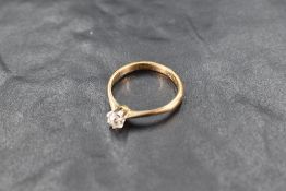 A diamond solitaire ring, approx 0.25ct in a six claw setting to knife blade shoulders on an 18ct