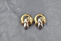 A pair of 18ct white and yellow gold clip on earrings of circular form, approx 7g