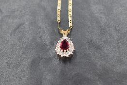 A teardrop ruby and diamond cluster pendant in a white gold mount with yellow gold loop, no marks,