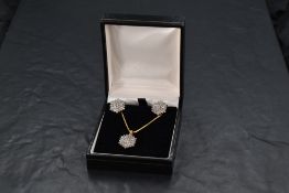 A pair of multi stone diamond cluster 18ct gold earrings having loop and post backs and a matching