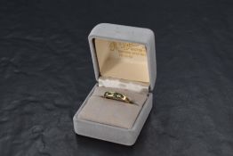 A 9ct gold half eternity ring having three emeralds interspersed by three diamonds, total approx 0.