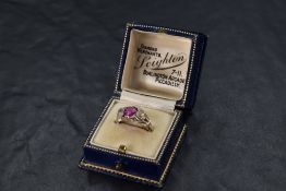 A Victorian ruby and diamond ring, the central ruby approx 1.25ct flanked by two old cut diamonds,