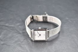 A Larsson & Jennings steel wrist watch having baton numeral dial to square face on a woven strap, in