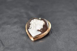A conche shell heart shaped cameo brooch/pendant depicting a maiden in profile in an 18ct gold