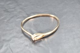 A 9ct gold Artisan style tension bangle having ball and loop clasp, approx 22.1g