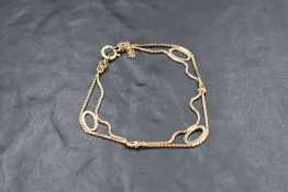 A 9ct gold double chain bracelet having oval spacers and safety chain, approx 4.8g