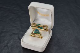 A yellow metal ring stamped 14K having a triangular faux black opal with diamond half surround in
