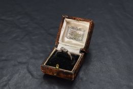 A two stone diamond ring, total approx 0.5ct to diamond chip set crossover shoulders on a white