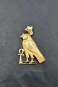 An 18ct Egyptian gold pendant in the form of a hooded falcon and Ankh, approx 9.3g