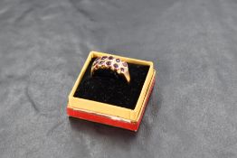 A ruby and diamond ring having a double row of collar set rubies interspersed by a row of diamond