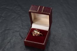 A 1990's ruby and diamond firebird ring by Franklin Mint having a central row of diamonds within two