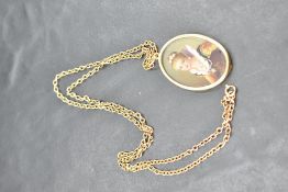 An Italian miniature portrait pendant depicting a gem set maiden in an 18ct gold mount on a 9ct gold