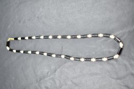An onyx bead and seed pearl necklace having 9ct gold clasp, approx 16'