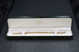 A multicoloured (fancy) sapphire set 9ct gold articulated bracelet with box clasp, approx 8.6g