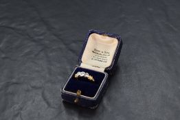 A diamond trilogy ring, total approx 0.5ct in a collared mount with moulded shoulders on an 18ct