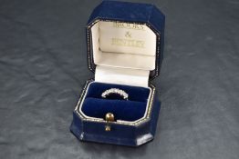 A five stone brilliant cut diamond eternity ring, approx 1.25ct in a bar set mount on a platinum