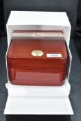 An Omega branded mahogany watchcase, with plush interior, sold with outer card box, operating