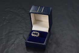 A 1970's three stone sapphire ring having three oval sapphires within a surround of brilliant cut