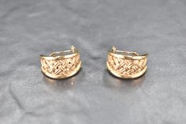 A pair of 9ct gold half hoop earrings having plaited decoration and bar and hoop fittings, approx