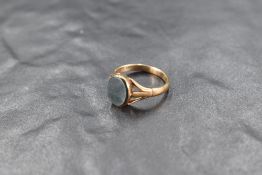 A small 9ct gold signet ring having oval blood stone panel & open shoulders, size K & approx 2.3g
