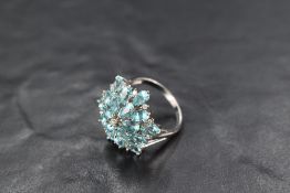 A large sea green apatite and diamond chip hexagonal cluster ring having open shoulders on a 9ct