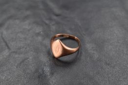 A rose gold signet ring having worn engraving to oval panel on a gold loop, marks worn, presumed