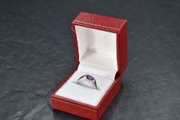 An amethyst set band ring having amethyst set shoulders and a 9ct white gold loop, size N & approx