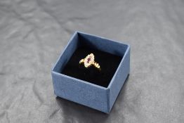 A ruby and diamond navette ring having three central rubies within a surround of old cut diamonds,