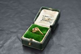 A diamond and ruby trio ring having cross over shoulders on an 18ct gold loop, size M & approx 2.7g