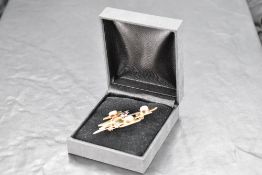 A silver and silver gilt artisan brooch of stylised form having moonstone and opal decoration,